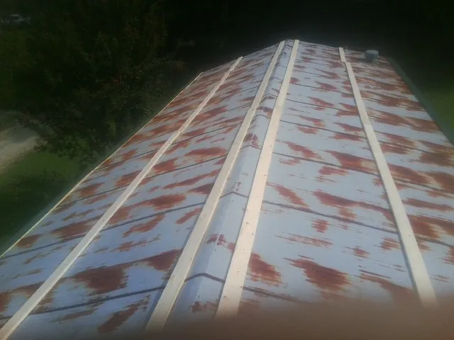 Rusted metal roof panels with new wood purlins before replacement — Storm Damage Roof Repair in Diamond Bar by Roofing Brothers