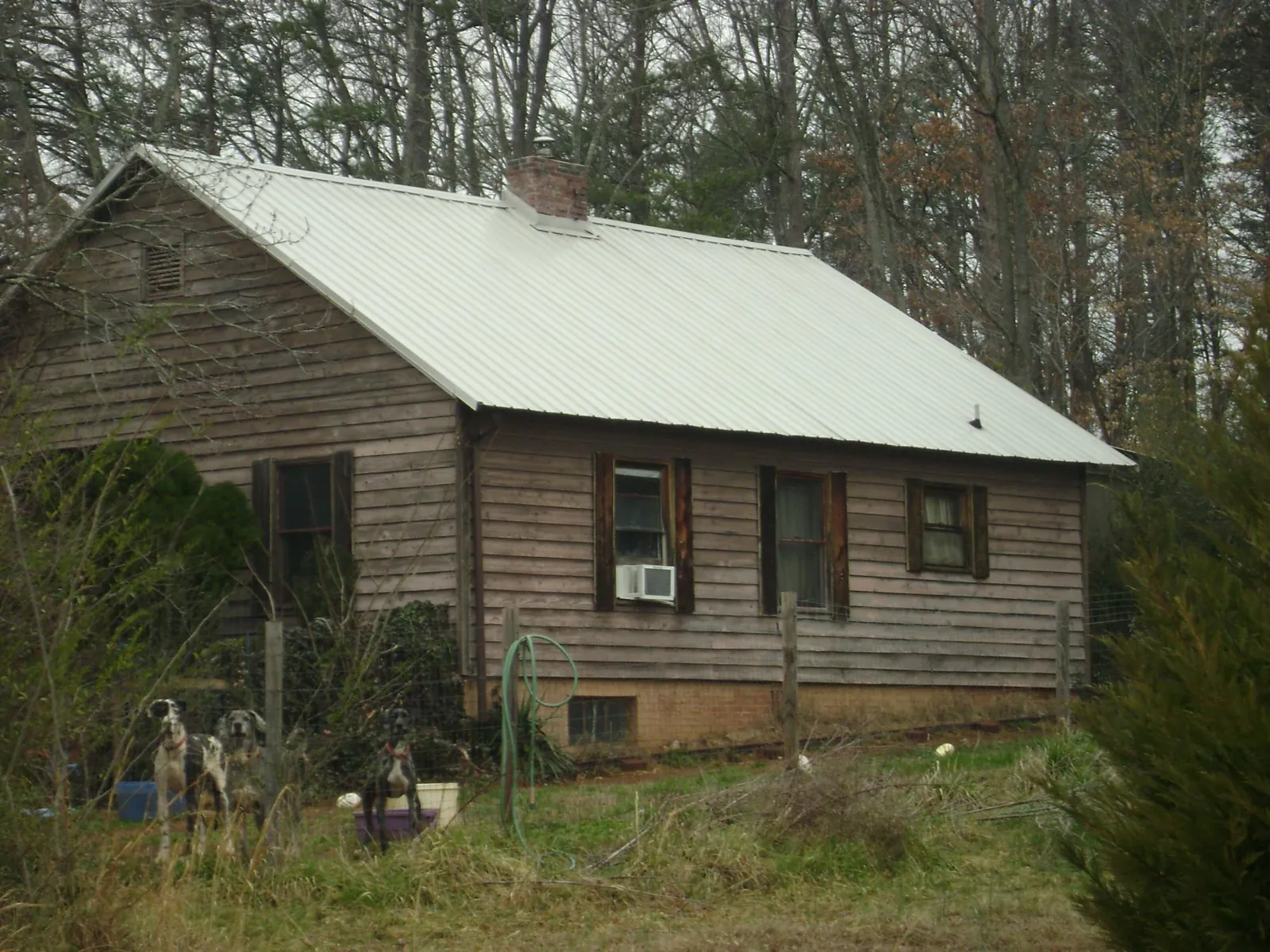 White metal roof on an old wood sided farmhouse, from a Metal Roof Installation job in Diamond Bar
